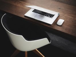 a chair and laptop in the library